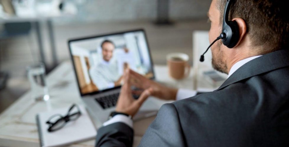 closeup-entrepreneur-using-laptop-while-having-online-business-meeting-office